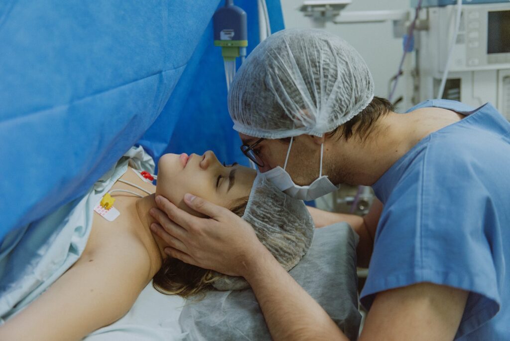 man kissing woman in hospital during labor